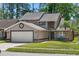 Charming two-story home featuring a well-maintained lawn, two-car garage, and inviting front entrance at 10783 Satinwood Cir, Orlando, FL 32825
