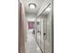 Hallway with a large bathroom featuring double sinks, a tub and shower, and dark wood cabinets at 10783 Satinwood Cir, Orlando, FL 32825