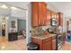 Warm kitchen featuring granite countertops, stainless appliances, and wood cabinetry at 10783 Satinwood Cir, Orlando, FL 32825