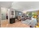 Open-concept living room with tile flooring, neutral colors, and ample natural light at 10783 Satinwood Cir, Orlando, FL 32825