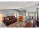 Open concept living room featuring hardwood floors, neutral walls, and a view of the staircase at 10783 Satinwood Cir, Orlando, FL 32825