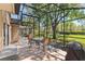 Outdoor patio with screened enclosure, perfect for entertaining with dining table and grill at 10783 Satinwood Cir, Orlando, FL 32825