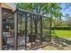 Screened patio with seating and grill, perfect for outdoor dining and entertaining at 10783 Satinwood Cir, Orlando, FL 32825