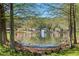 Scenic view of the pond with a fountain and lush greenery at 10783 Satinwood Cir, Orlando, FL 32825