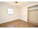 Bright bedroom featuring neutral walls, tile floors, and an open closet ready to be personalized at 122 W Hillcrest St, Altamonte Springs, FL 32714