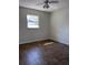 Cozy bedroom with neutral paint, tiled flooring, and a sunlit window at 122 W Hillcrest St, Altamonte Springs, FL 32714