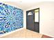 Modern entryway showcasing unique wall art, a sleek front door, and stylish tile flooring at 122 W Hillcrest St, Altamonte Springs, FL 32714