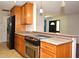 Modern kitchen with stainless steel stove, granite counters, wood cabinets at 122 W Hillcrest St, Altamonte Springs, FL 32714
