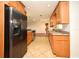 Open kitchen featuring stainless steel refrigerator, granite countertops and hardwood floors at 122 W Hillcrest St, Altamonte Springs, FL 32714