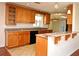 Well-equipped kitchen with granite counters, wood cabinets, and breakfast bar at 122 W Hillcrest St, Altamonte Springs, FL 32714
