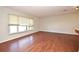 Sunlit living room boasts hardwood floors, an open layout, and large window that fills the space with light at 122 W Hillcrest St, Altamonte Springs, FL 32714