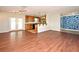Open-concept living area featuring hardwood floors and seamless flow to the kitchen at 122 W Hillcrest St, Altamonte Springs, FL 32714