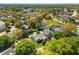 Aerial view showcases the home's mature trees and landscaping, as well as the community pond at 12712 Forestedge Cir, Orlando, FL 32828