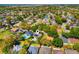 Aerial view of a residential area featuring well-maintained homes with lush landscaping and mature trees at 12712 Forestedge Cir, Orlando, FL 32828