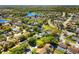 Aerial view of a residential neighborhood with winding roads, green spaces, and a tranquil lake at 12712 Forestedge Cir, Orlando, FL 32828
