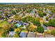 Aerial view of a residential area featuring well-maintained homes with lush landscaping and mature trees at 12712 Forestedge Cir, Orlando, FL 32828