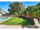 Beautifully landscaped backyard featuring a pool, lush lawn, and vibrant flower beds at 12712 Forestedge Cir, Orlando, FL 32828