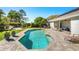 Backyard featuring a sparkling pool, patio, lounge chairs, and meticulous landscaping for outdoor enjoyment at 12712 Forestedge Cir, Orlando, FL 32828