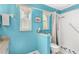 Bathroom featuring blue walls, toilet, and shower with glass doors and white tile at 12712 Forestedge Cir, Orlando, FL 32828