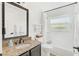 Bathroom features a vanity with granite countertop, a bathtub, and a window with natural light at 12712 Forestedge Cir, Orlando, FL 32828