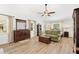Bright and airy bedroom with vaulted ceilings, wood floors, dresser, and natural light from the windows at 12712 Forestedge Cir, Orlando, FL 32828