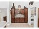 Butler pantry features brown cabinetry, stone countertop, and decorative glass cabinets above countertop at 12712 Forestedge Cir, Orlando, FL 32828