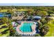 Aerial view of the community pool area featuring a pool, playground, and recreational facilities at 12712 Forestedge Cir, Orlando, FL 32828