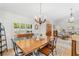 Bright dining room featuring a large table with stylish seating and shutters at 12712 Forestedge Cir, Orlando, FL 32828