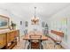 Formal dining room with chandelier lighting and shuttered doors at 12712 Forestedge Cir, Orlando, FL 32828