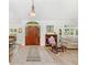 Spacious foyer features tile flooring, wood door, and natural light at 12712 Forestedge Cir, Orlando, FL 32828