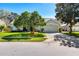 Charming single-story home features a manicured lawn and mature shade trees at 12712 Forestedge Cir, Orlando, FL 32828