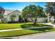 Charming single-story home features a manicured lawn and mature shade trees at 12712 Forestedge Cir, Orlando, FL 32828