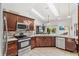 Updated kitchen features modern stainless appliances and a tile backsplash at 12712 Forestedge Cir, Orlando, FL 32828
