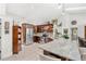 Bright kitchen features stainless steel appliances, brown cabinetry and stone countertops with a breakfast bar at 12712 Forestedge Cir, Orlando, FL 32828