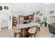 Open kitchen with stainless steel appliances, granite countertops, bar seating, and decor shelves at 12712 Forestedge Cir, Orlando, FL 32828