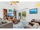 Comfortable living room with sliding door access to the backyard pool area at 12712 Forestedge Cir, Orlando, FL 32828