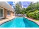 Inviting backyard pool surrounded by mature landscaping and a fence at 1272 Mount Logan Dr, Apopka, FL 32712