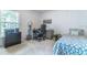 Bedroom features a desk and a bed with blue patterns at 1272 Mount Logan Dr, Apopka, FL 32712