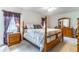 Bright, spacious bedroom with a four-poster bed and coordinating furniture at 1272 Mount Logan Dr, Apopka, FL 32712