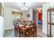 Traditional dining room with wood table, chandelier and view to bedroom at 1272 Mount Logan Dr, Apopka, FL 32712