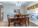 Traditional dining room with wood table, six chairs, and large window at 1272 Mount Logan Dr, Apopka, FL 32712