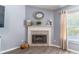 Corner fireplace with tile surround and mantle in gray living room at 1272 Mount Logan Dr, Apopka, FL 32712