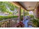 Cozy front porch with seating, surrounded by lush greenery and charming details at 1272 Mount Logan Dr, Apopka, FL 32712