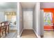 Bright hallway leading to various rooms with wood-look flooring and neutral paint at 1272 Mount Logan Dr, Apopka, FL 32712