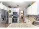 Stylish kitchen featuring granite countertops, stainless steel appliances, and modern white cabinetry at 1272 Mount Logan Dr, Apopka, FL 32712