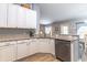 Well-lit kitchen with stainless appliances, granite countertops, and white cabinets with ample storage at 1272 Mount Logan Dr, Apopka, FL 32712