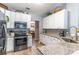 Modern kitchen with granite countertops, stainless appliances, and a seamless design for efficient cooking at 1272 Mount Logan Dr, Apopka, FL 32712