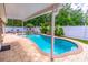 Covered patio overlooking a custom pool with waterfall feature at 1272 Mount Logan Dr, Apopka, FL 32712