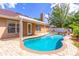 Beautiful backyard with a sparkling pool, covered patio, and well-maintained landscaping at 1272 Mount Logan Dr, Apopka, FL 32712