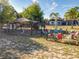 Spacious backyard featuring a cozy fire pit with colorful chairs and a charming chicken coop under a shaded structure at 133 Orange Ridge Dr, Longwood, FL 32779